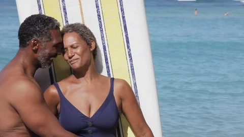 Middle-aged couple embracing on a beach. 스톡 동영상 88367549
