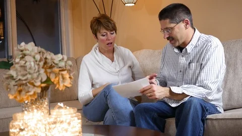 Middle Aged couple is happy about their tax return ALT Video stock 83962945