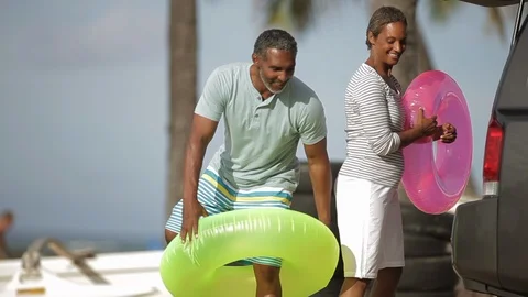 Middle-aged couple with inner tubes. Video stock 88370450