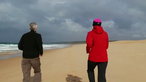 Middle-aged Couple Jogging on Beach Stock Footage 45506925