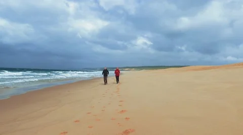 Middle-aged Couple Jogging on Ocean Sandy Beach Stock Footage 68175770
