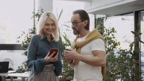 Middle-aged couple looking at message on smartphone Stock Footage 152855159