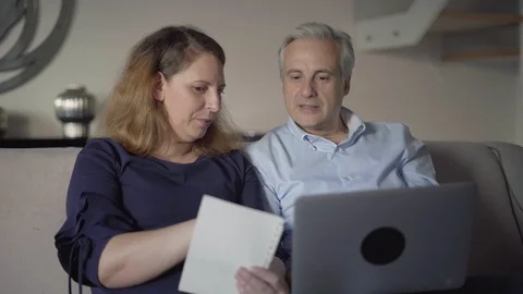 Middle aged couple purchasing online with shopping list Video stock 101370756