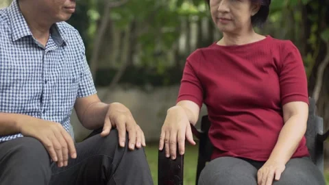 Middle aged couple relax sitting on bench in backyard. Stock Footage 133408947