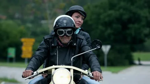 Middle aged couple on retro motorcycle Stock Footage 28983697
