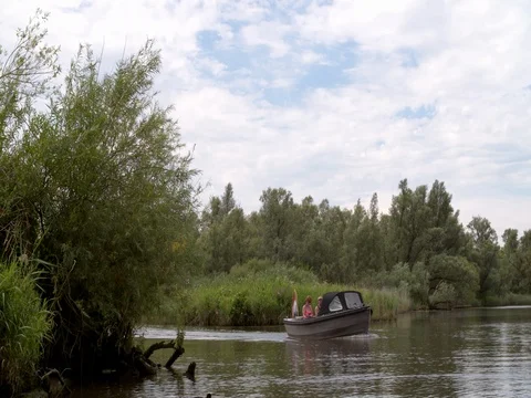 Middle aged couple sailing a longboat at Dutch national park Stock Footage 77400183