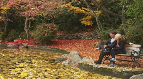 Middle-Aged Couple Sitting on Park Bench 1 Stock Footage 35320668