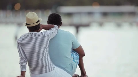 Middle-aged couple sitting by the sea. 스톡 동영상 88370612