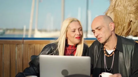 Middle aged couple sitting using laptop Stock Footage 171139225