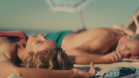 Middle-aged couple sleeping at the beach Stock Footage 262390225