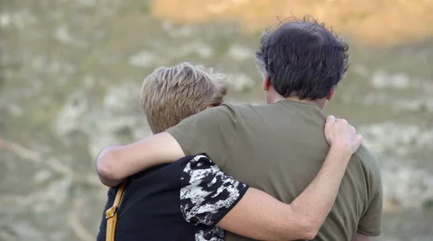  middle-aged couple standing back while embracing tenderly Stock Footage 67817136