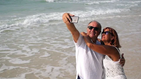 Middle-Aged Couple Taking Selfie with Mobile Phone at Beach Видео 73930865