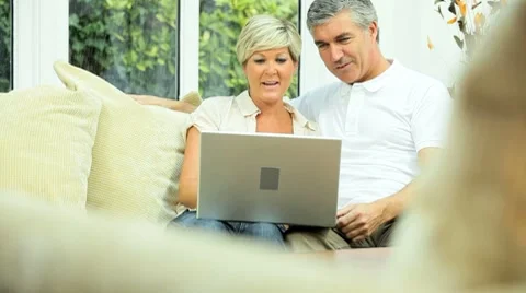 Middle Aged Couple Using Home Laptop Stock Footage 8688549