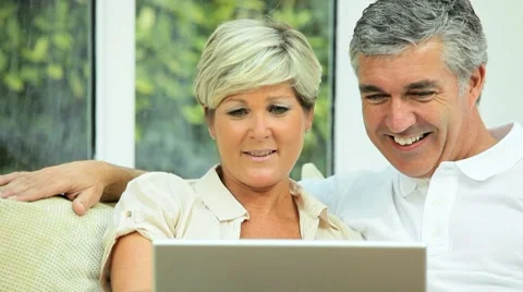 Middle Aged Couple Using Online Webchat at Home Stock Footage 8688100