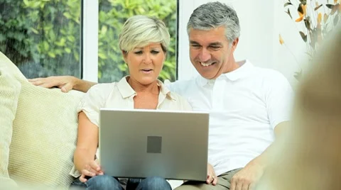 Middle Aged Couple Using Online Webchat at Home Stock Footage 8688166