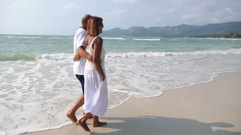 Middle Aged Couple Walking on Beach. Slow Motion Stock-Footage 73930804