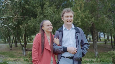 Middle-aged couple walking in the park,The woman is dressed in red Stock Footage 129503556