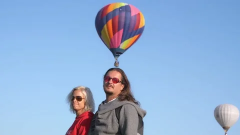 Middle Aged Couple Watching Balloons Flying. Man and Woman Together Looking at Stock Footage 147435164