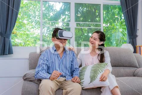 Middle-aged couples, men trying to play VR glasses, women laughing like men, Stock Photos