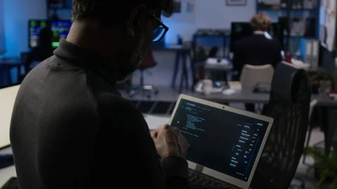 Middle Aged Cybersecurity Analyst Coding on Laptop in Modern Office Stock Footage 347301462
