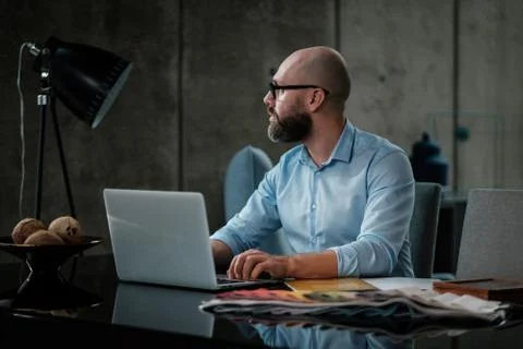 Middle-aged designer working in office Stock Illustration