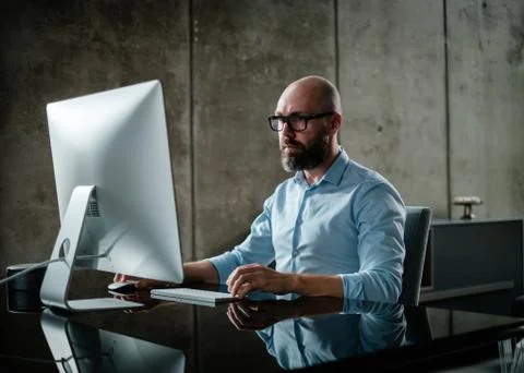 Middle-aged designer working in office Stock Photos
