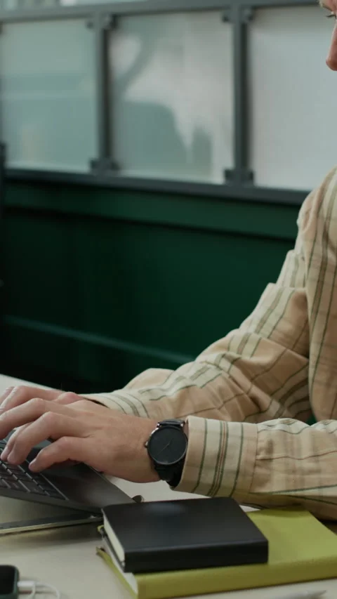 Middle-Aged Developer Typing on Laptop in Modern Office Stock Footage 319995417
