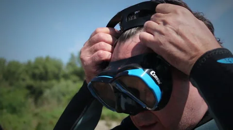 Middle aged diver putting his diving mask on Stock Footage 48383366