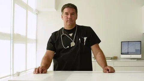 Middle aged doctor looking into camera 库存影片 93249688