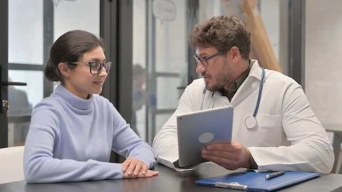 Middle Aged Doctor Sharing Good New to Female Patient in Clinic Video stock 307222644