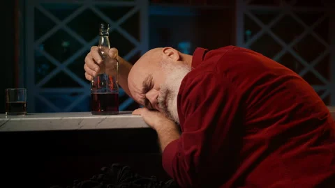 Middle-aged drunk man asleep with whiskey bottle at bar counter, alcoholism Stock Footage 346714107