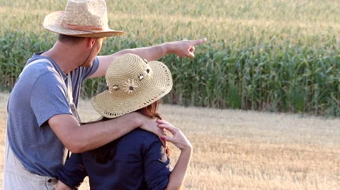 A middle-aged farmer watching the cornfield with his wife Stock Footage 54578639