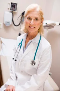 Middle Aged Female Doctor Sitting In A Hospital Ward Stock Photos