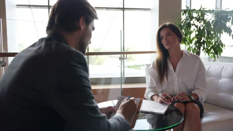Middle-aged female manager talking to business colleague in office, sharing idea Stock Footage 224499292