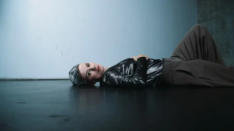 Middle Aged Female Performer Lying on Dance Floor Stock Footage 121107916