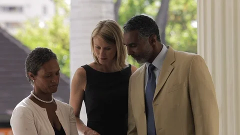 Middle-aged friends talking while one writes. Stock-Footage 88368887