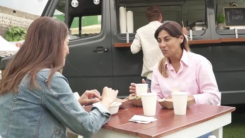 Middle aged girlfriends having lunch in park Stock Footage 269341520