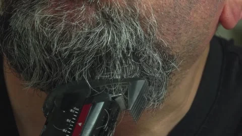 Middle-Aged Guy Safely Trimming Jawline Beard via Electric Razor Stock Footage 337164609