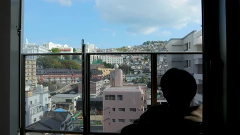 Middle aged guy sit and relax on balcony. Silhouette. Stock Footage 224903018