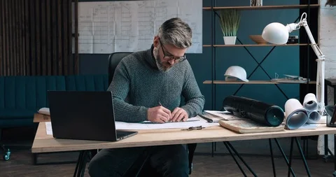 Middle aged Handsome Architect working at his Office, making Drawings. Looking Видео 126243341