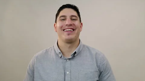Middle-aged handsome Hispanic man laughing heartily at camera, medium short Stock Footage 248748768