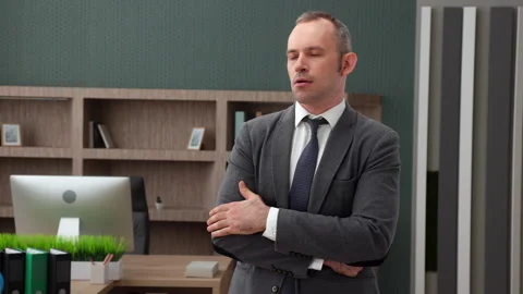 Middle-aged handsome man in formal outfit concentrated on solving problem Stock Footage 250372479