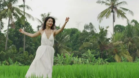 Middle aged happy and elegant woman dancing free at nature rice terrace Stock Footage 132234438