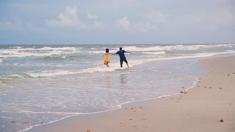 Middle Aged, Happy Couple Dancing, Being Silly Together &amp; Getting Wet At A Beach Stock Footage 102585375