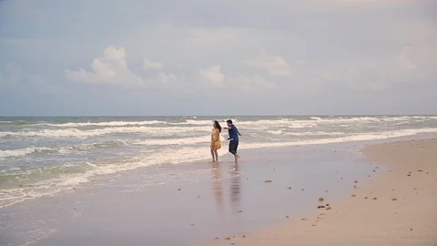 Middle Aged, Happy Couple Dancing At The Beach, In The Water With Arms Extended Stock Footage 102585532