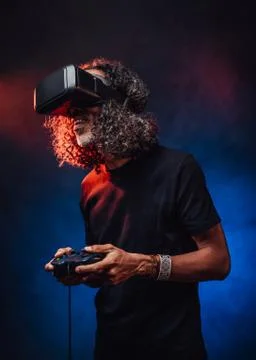 Middle aged hispanic male playing with virtual reality glasses and video game 스톡 사진