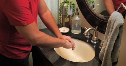 Middle-aged hispanic man washes hands in bathroom. Video stock 139468364