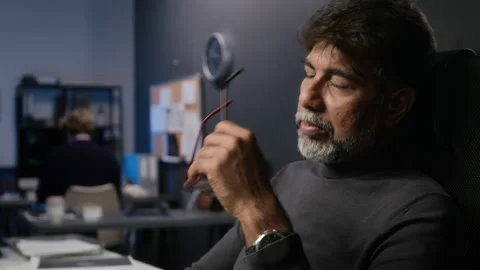 Middle Aged Indian Cybersecurity Analyst Feeling Fatigued at Work Video stock 347285901