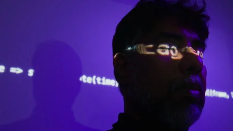 Middle Aged Indian Developer Standing under Projected Code on Face Stock Footage 347288264