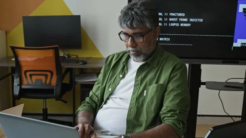 Middle Aged Indian IT Teacher Coding on Laptop in Classroom Stock Footage 342821242